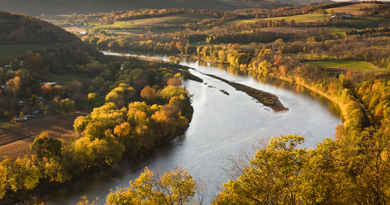 Peaceful river scene in Pennsylvania with glowing city lights representing hope and healing through Pennsylvania intervention support.