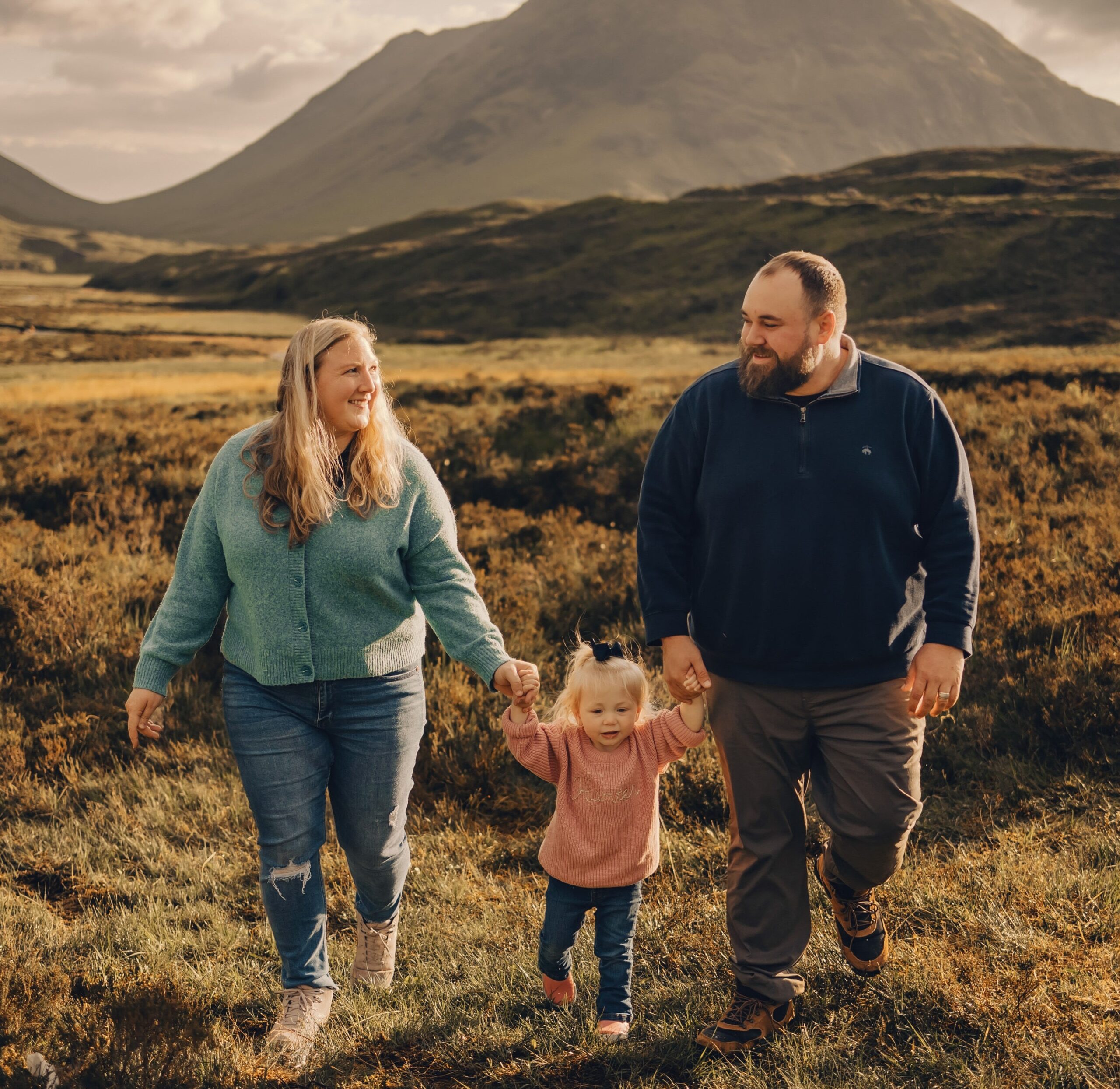 Matt and Hannah walking hand in hand with their daughter Hunter